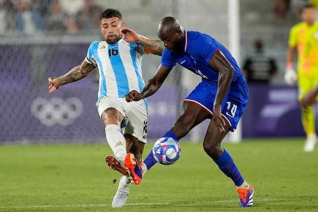 Duel Jean-Philippe Mateta dan Nicolas Otamendi dalam laga Prancis vs Argentina di Olimpiade 2024, Sabtu (3/8/2024). (c) AP Photo/Rebecca Blackwell